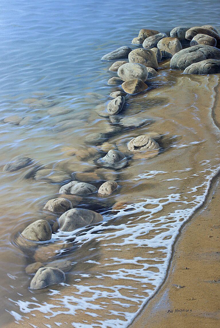 Photorealistic painting of smooth rocks along the side of a beach